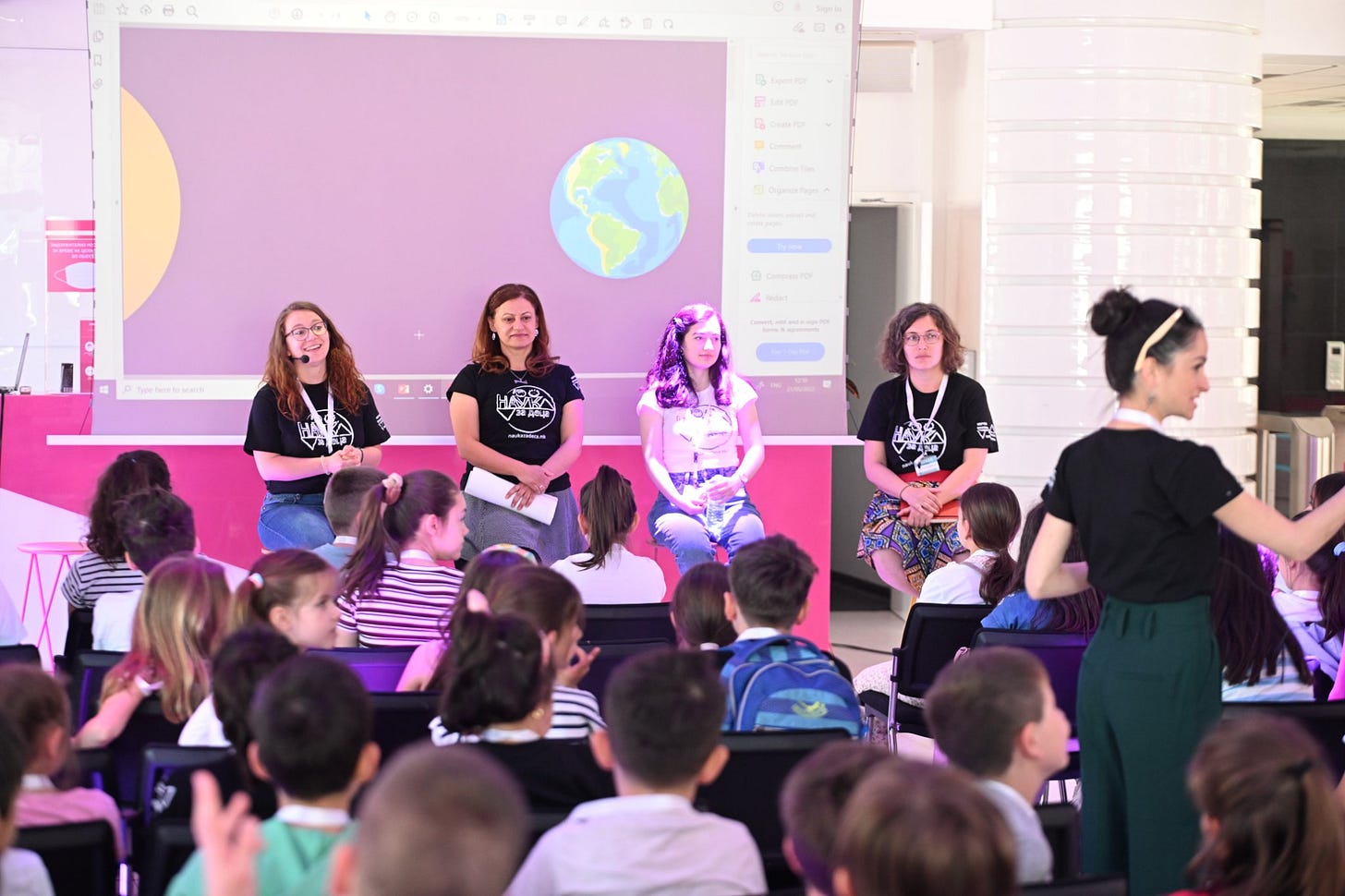 May be an image of 11 people, child, people sitting, people standing and indoor
