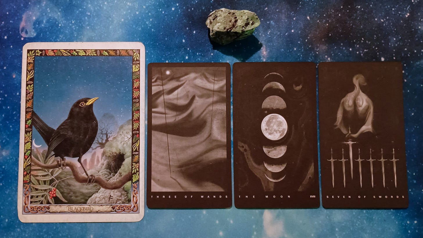 New Moon Magic: Your July 2025 Pick-a-Card Tarot Reading, pile 2 -ruby zoisite stone (green with black speckles) and 4 cards on a starry blue background