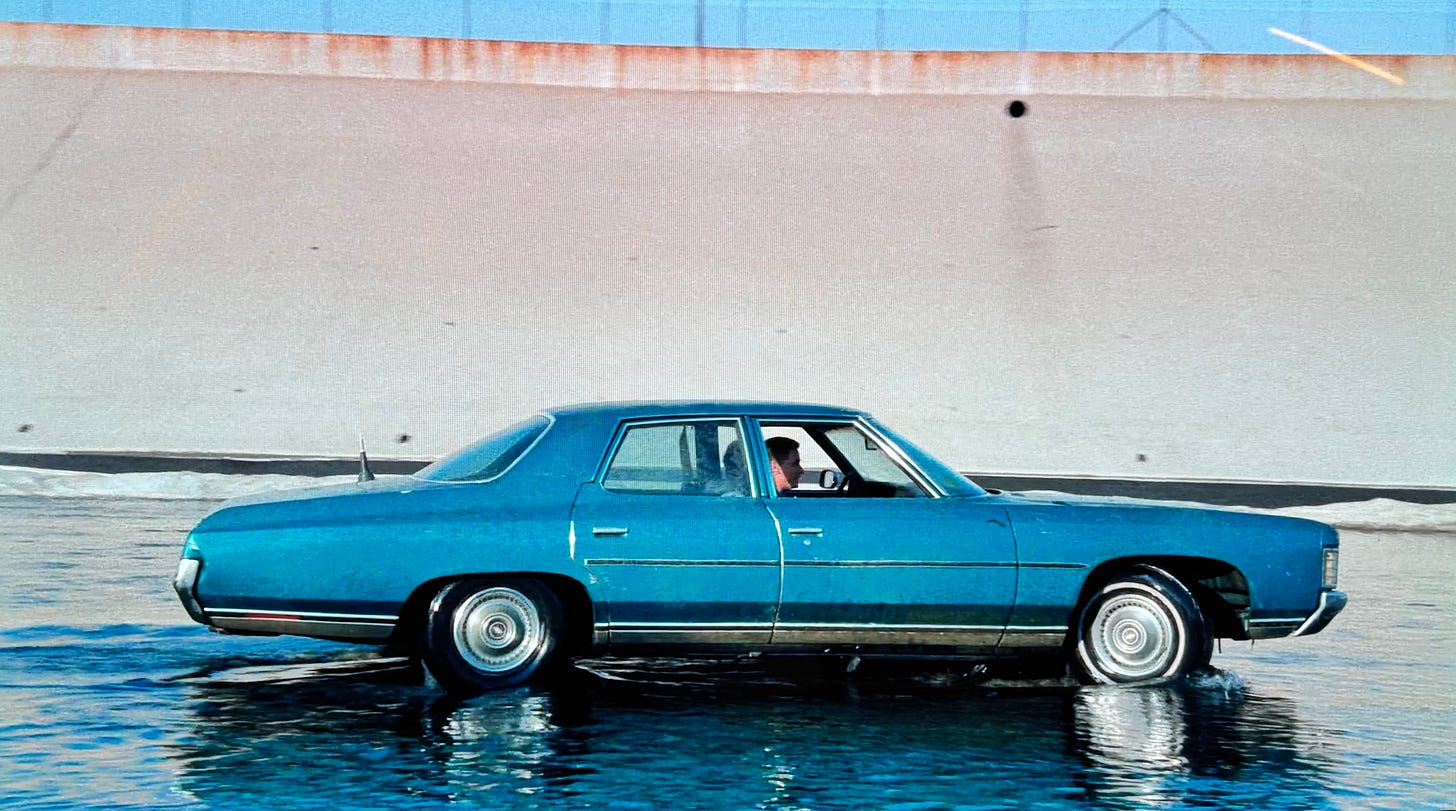 Blue Chevy Impala driving in Los Angeles River