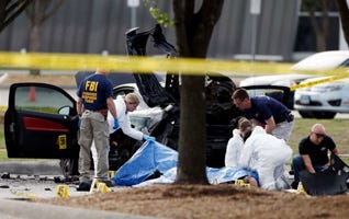 FBI crime scene investigators document the area around two deceased gunmen and their vehicle outside the Curtis Culwell Center in Garland, Texas, Monday FBI crime scene investigators document the area around two deceased gunmen and their vehicle outside the Curtis Culwell Center in Garland, Texas, Monday