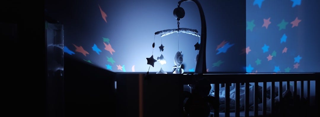 baby's black wooden crib with LED crib mobile