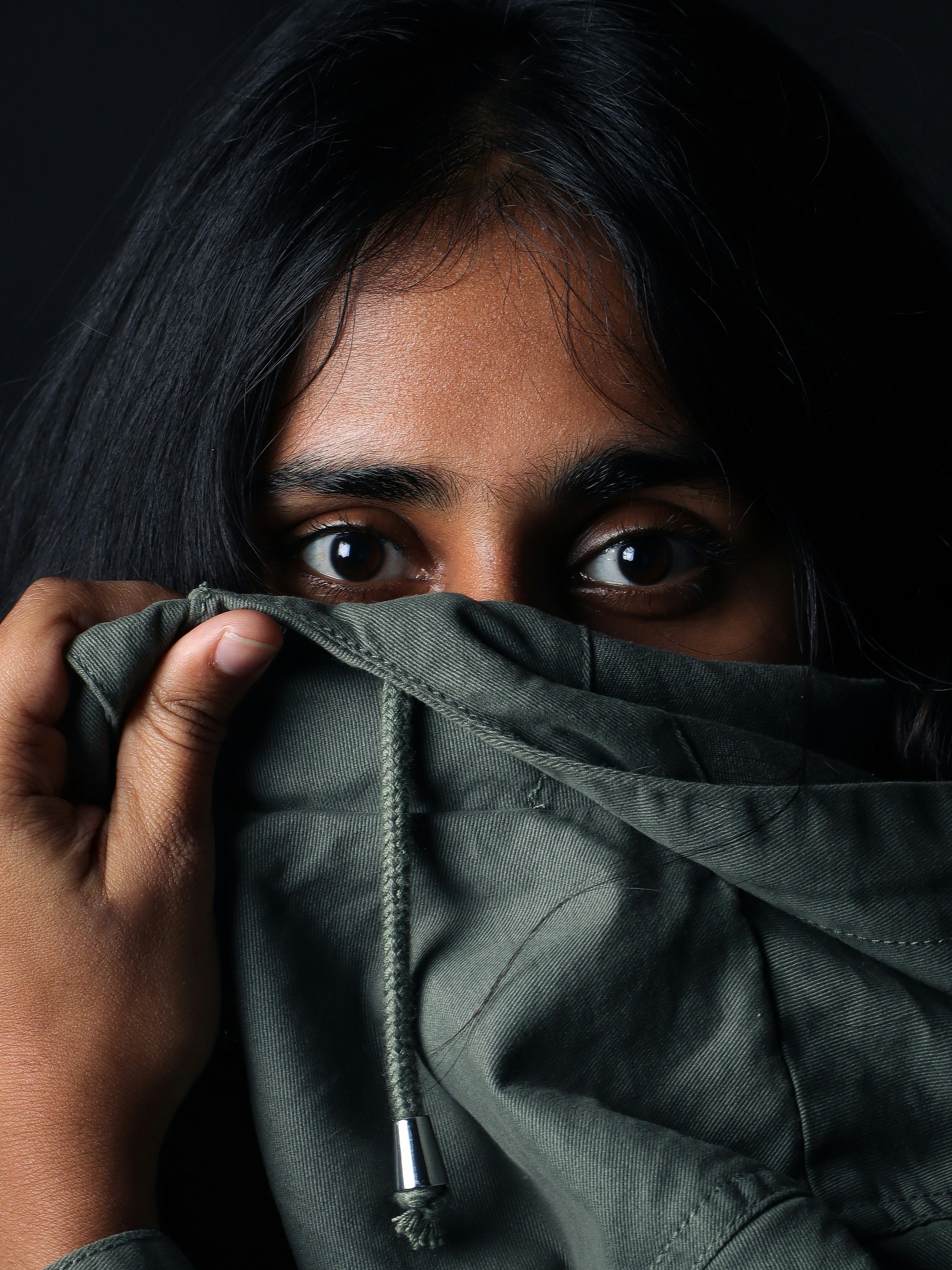 woman hiding part of her face woman hiding part of her face