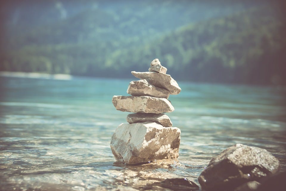 A pile of rocks balancing upon each other.