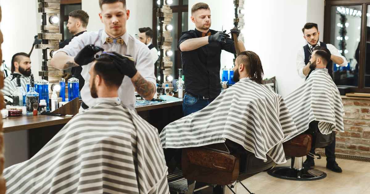3 men in the barber shop getting their haircut  