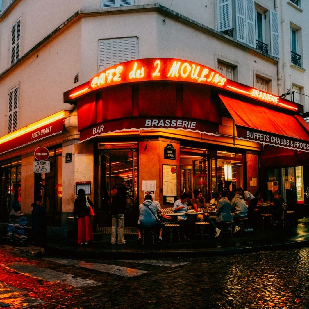 A restaurant with a red awning on a rainy day A restaurant with a red awning on a rainy day