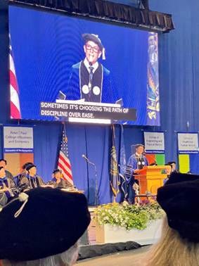 A group of people in a graduation gown

AI-generated content may be incorrect.