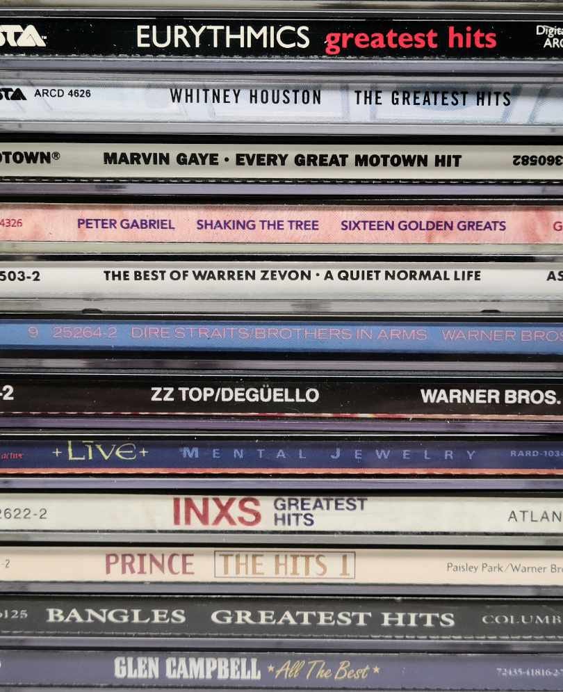 Photo of a stack of cd cases by various artists.