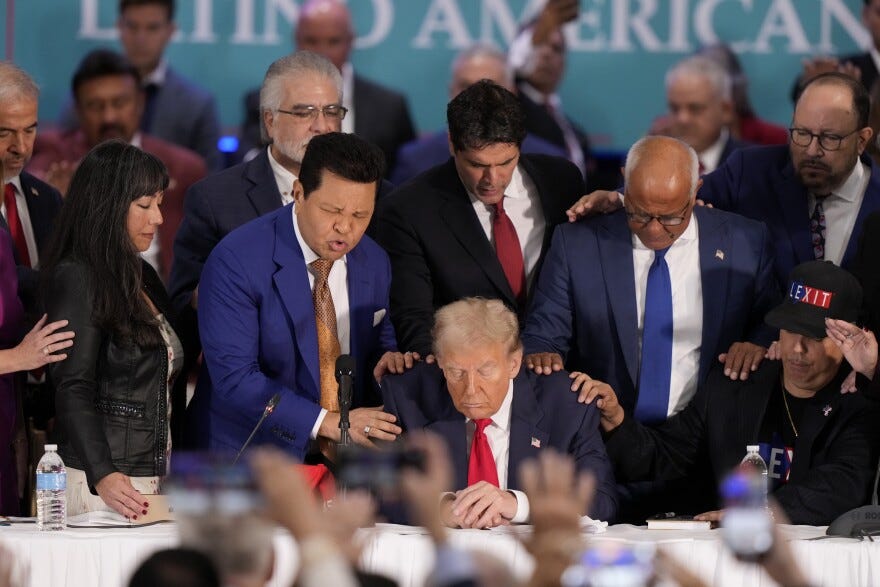Latino leaders pray with Republican presidential nominee former President Donald Trump, front center, as he participates in a roundtable with Latino leaders Tuesday, Oct. 22, 2024, in Doral, Fla. LYNNE SLADKY/AP