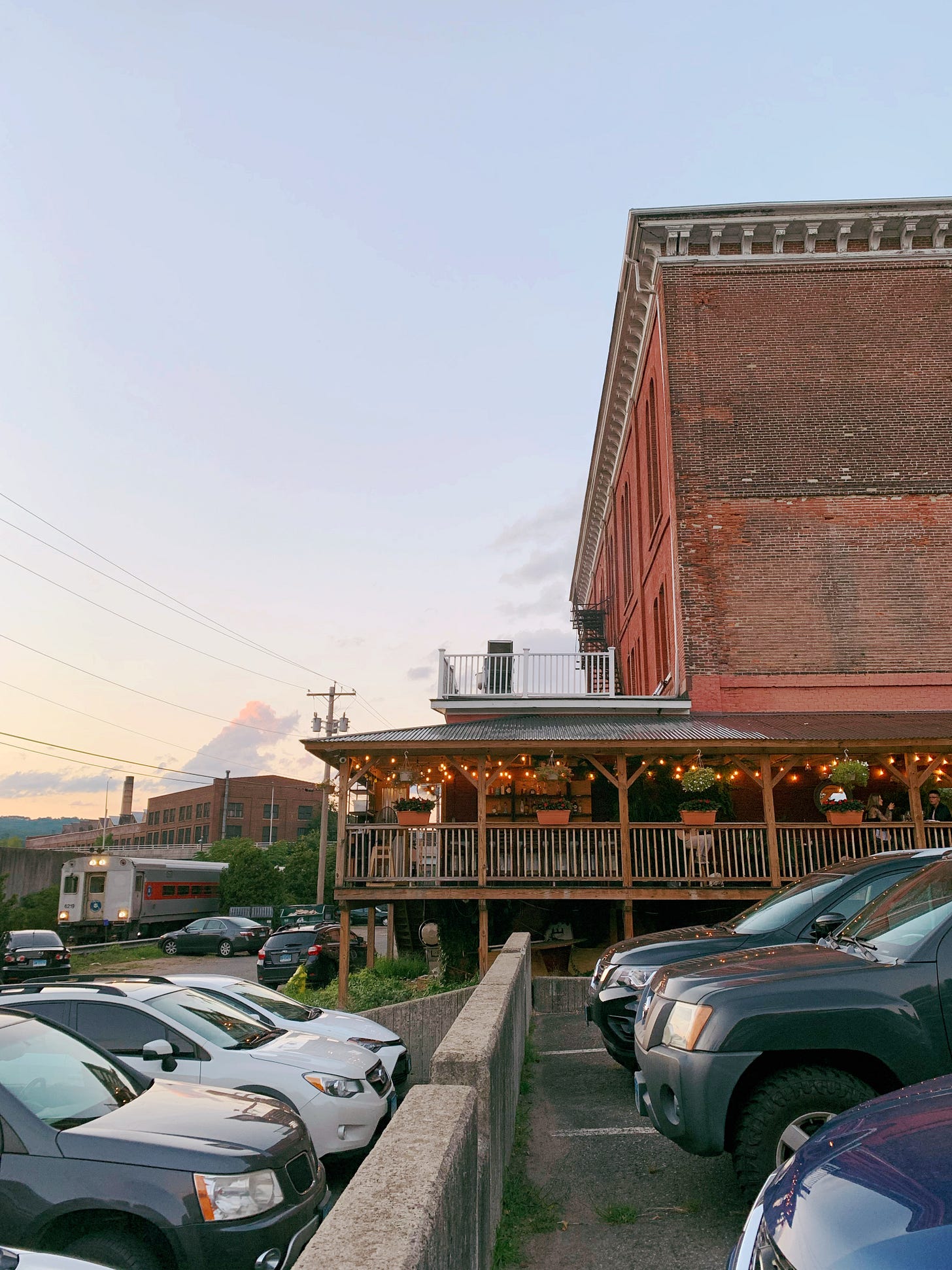 Restaurant with patio and train arriving at the station