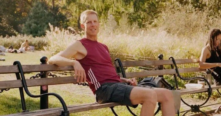 Low-impact lifestyle influencer Joshua Spodek sits on a bench in a park in New york City