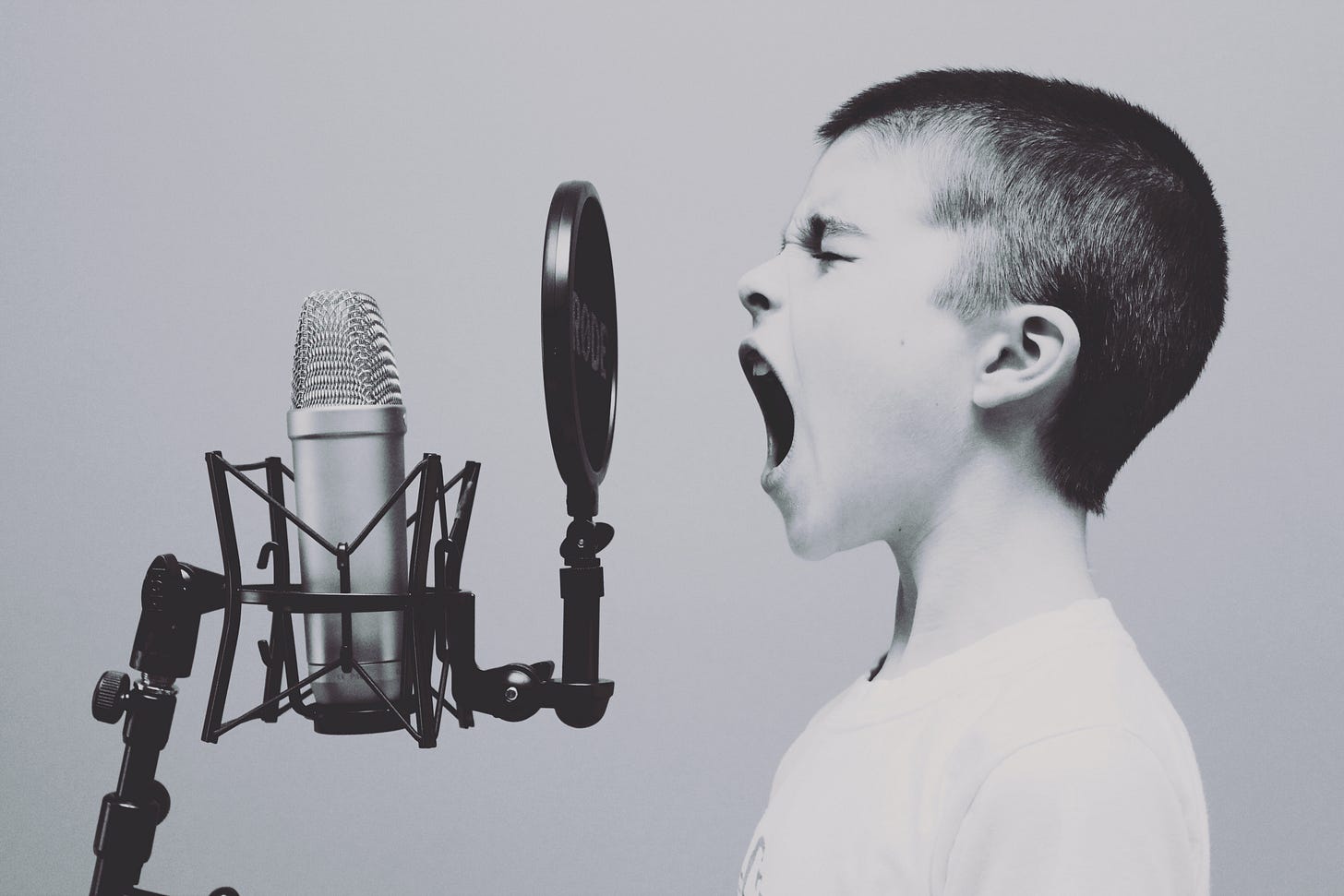 Boy yelling at microphone Boy yelling at microphone