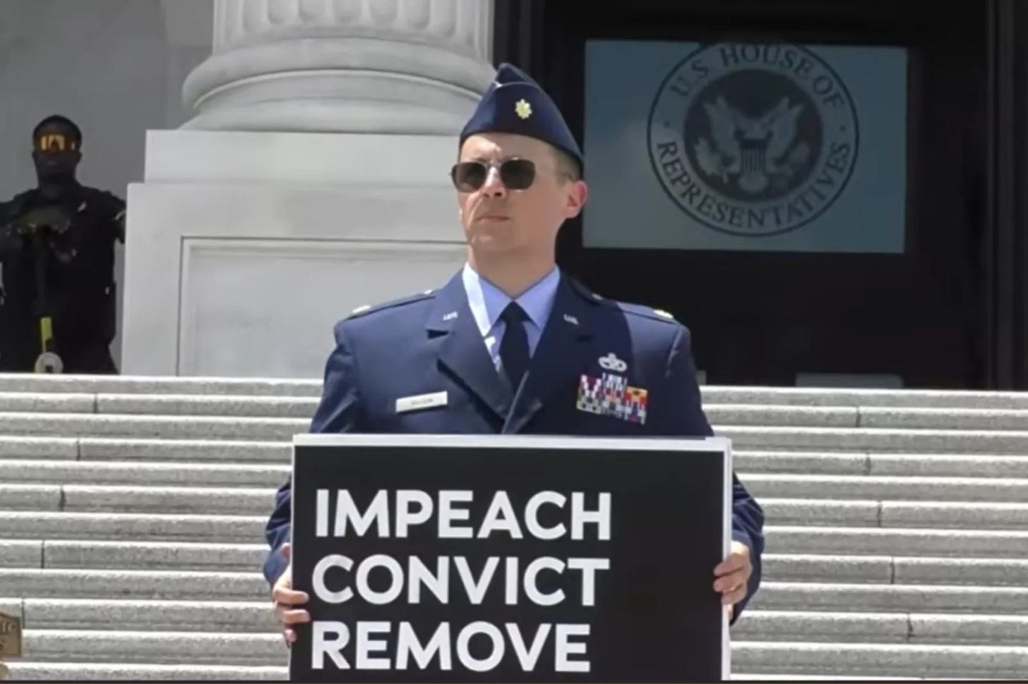 Major Jason Watson is seen in a still from a livestreamed video from the protest where he called for President Donald Trump's impeachment on July 1, 2026.