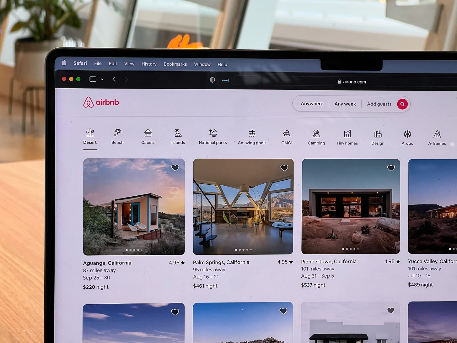 Person using Airbnb website on laptop to search and book travel stays