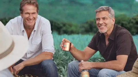 Casamigos Rande Gerber and George Clooney in field of agave in promotional shot for Casamigos