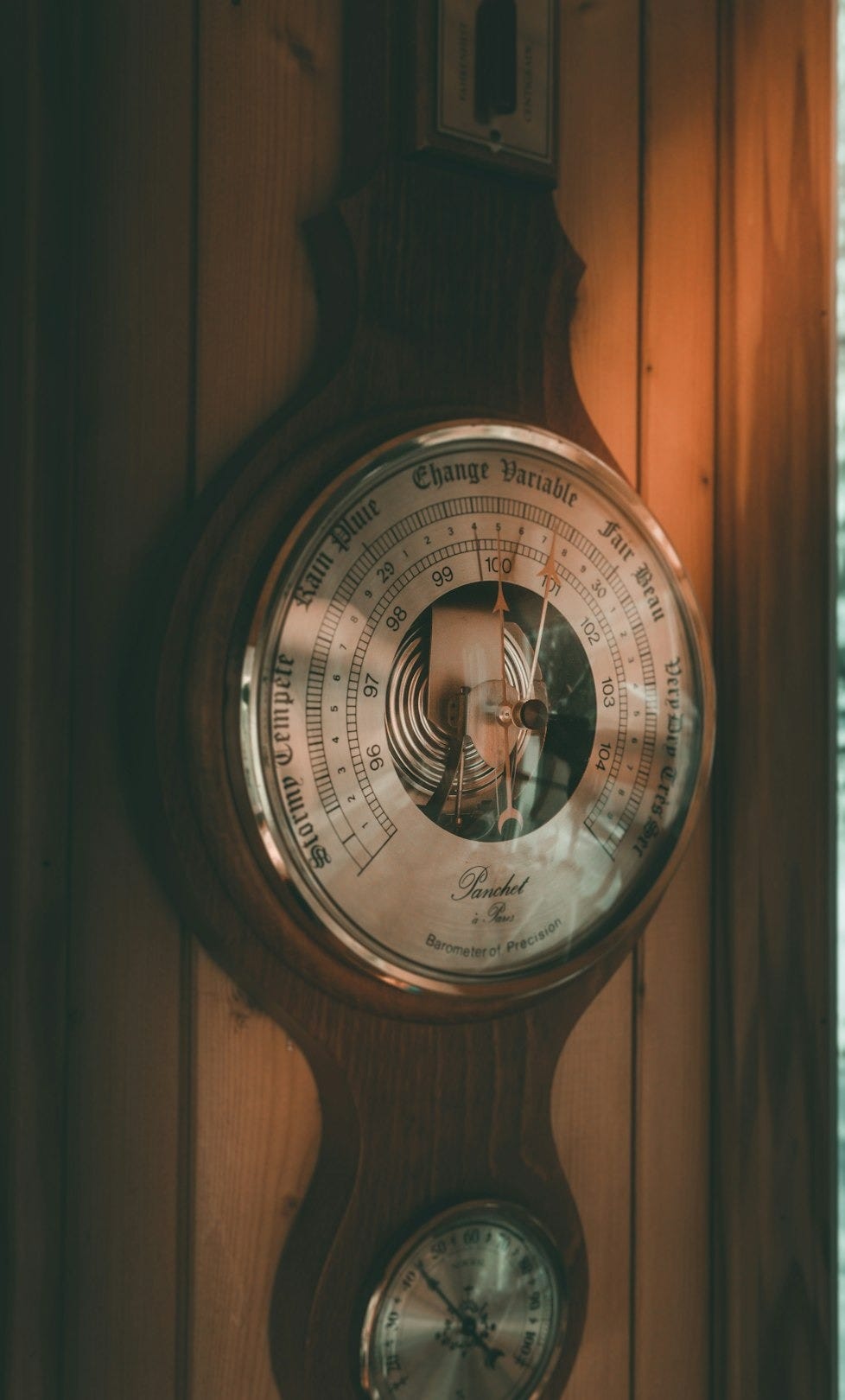 brown pendulum clock on wall