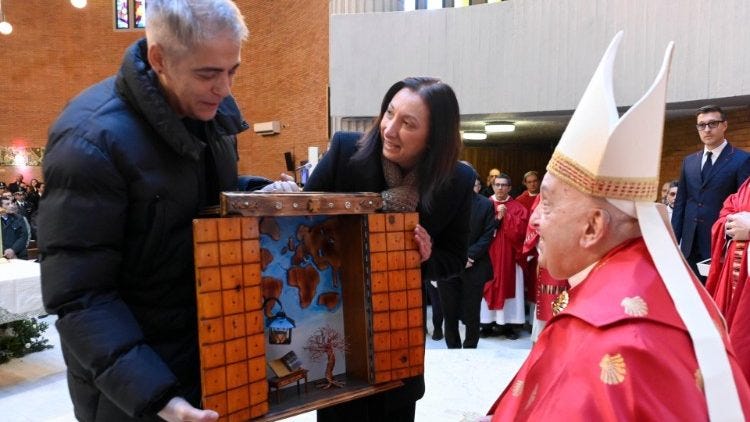 Members of the prison present the Pope with a replica of the Holy Door