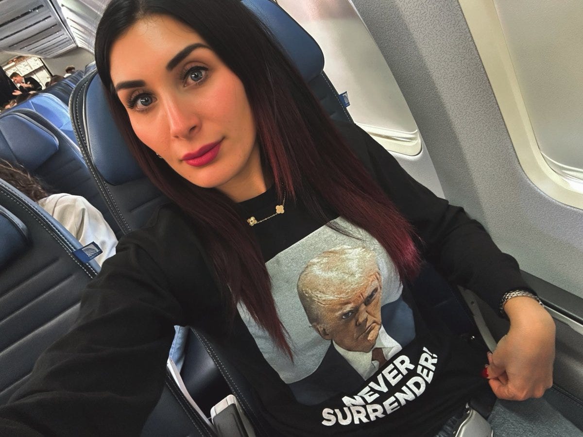 Laura Loomer wearing a Trump mugshot shirt