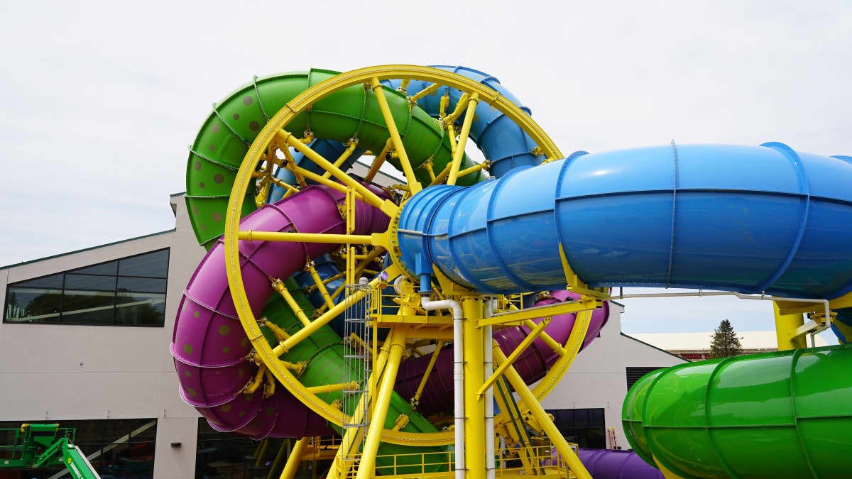 Large twisty water slide with multicolored exits that rotates