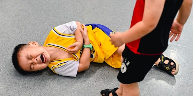 2 boys lying on the ground 2 boys lying on the ground