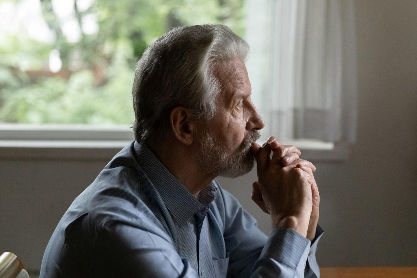 Sad older man look in distance feeling lonely depressed