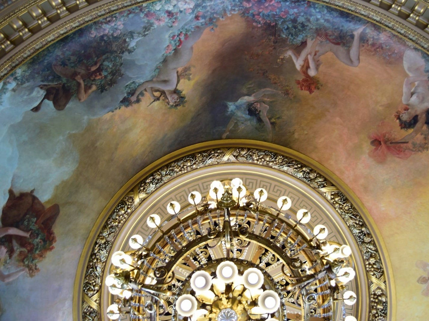 a ceiling with a painting of angels on it