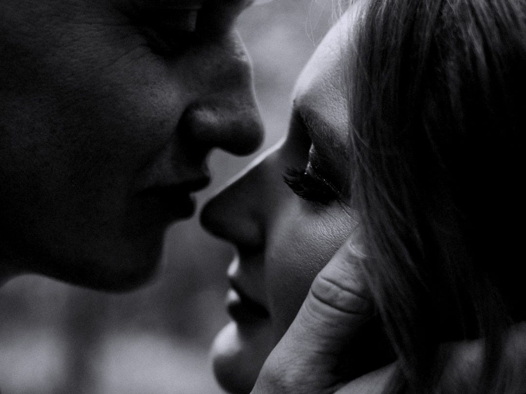 a woman kissing a man