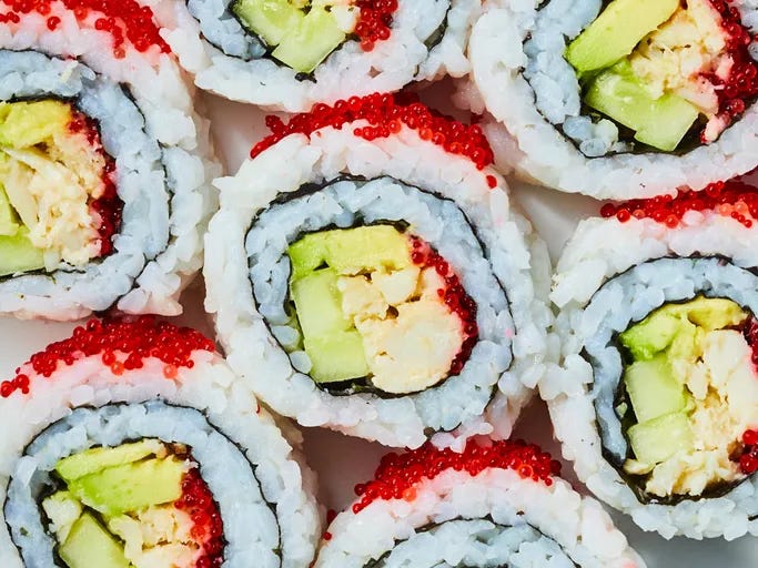 Looking down at a bunch of California rolls.