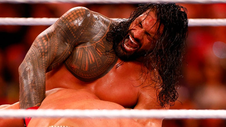Roman Reigns applies a choke