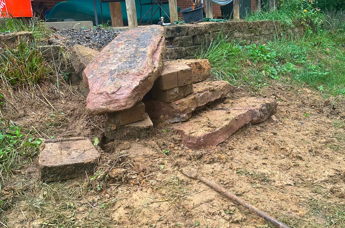 A set of rock steps under construction, one big rock is only partially in place