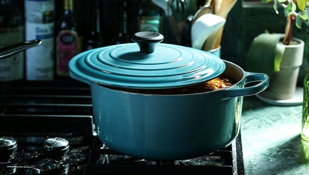 partly opened blue metal pot on stove