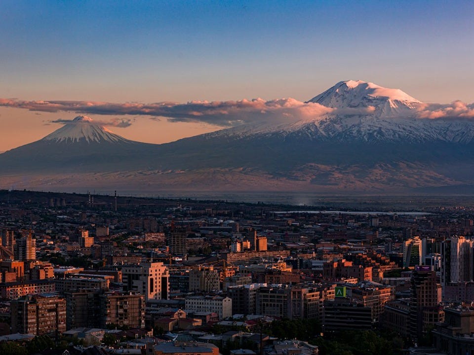 a view of a city with a mountain in the background a view of a city with a mountain in the background