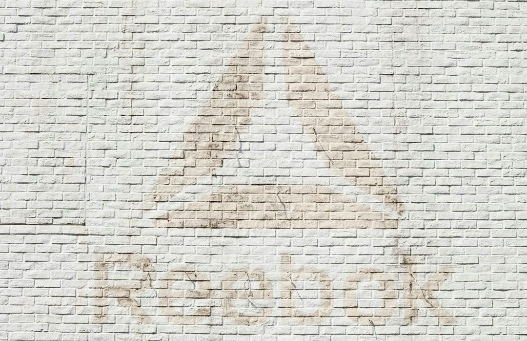close-up photo of Reebok logo on wall