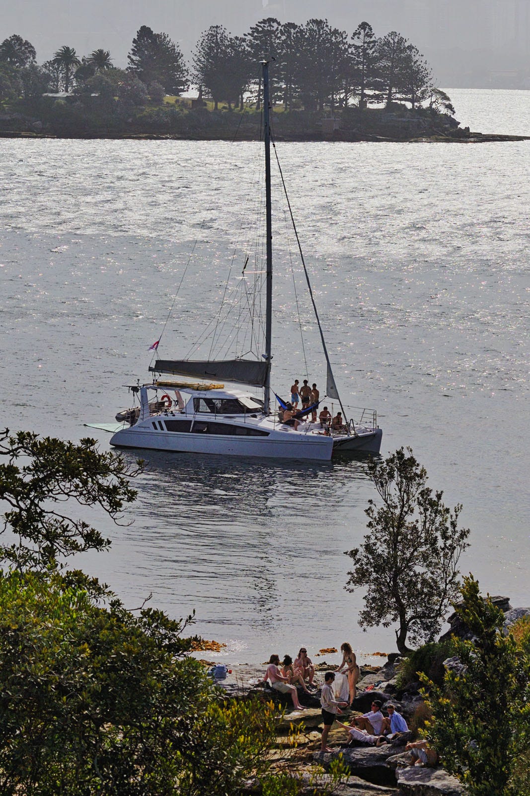 Detail - the parties on the catamaran and on the shore