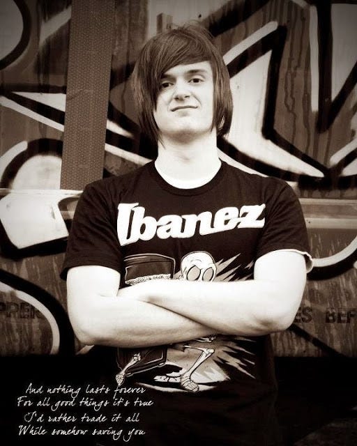 Black and white photo of Dylan Andrew Brown, age 18 years old. Dylan is staring straight at the camera, arms crossed, Ibanez guitar t-shirt, with grafitti wall behind him. My Forever Son: Chronicling grief, hope, and healing after losing my son to suicide, Ghost memories swirl everywhere
