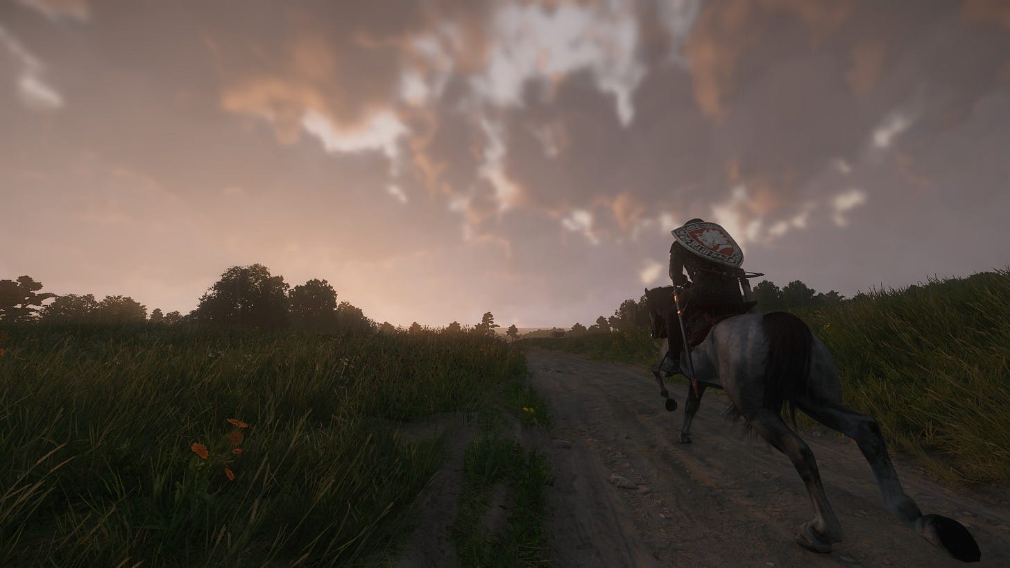 A screenshot of Kingdom Come: Deliverance II, showing the player character, Henry, riding the horse Pebbles on a dirt road as the sun sets on the horizon.