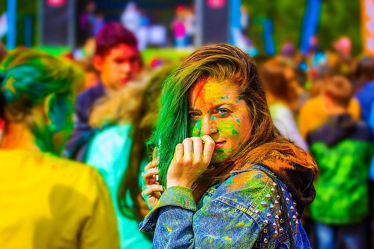 woman wearing blue denim jacket and painted her body