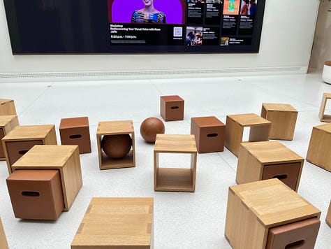 Image 1: Black and white panoramic photos documenting American history through the 70's|| My Apple Watch that I bought from the Carnegie Store|| Opened copy of Fourth Wing while I was reading it || An old Panoramic camera|| Negative film of a photo lined up with it's print|| the welcome area at the Apple store where people learn about Apple products