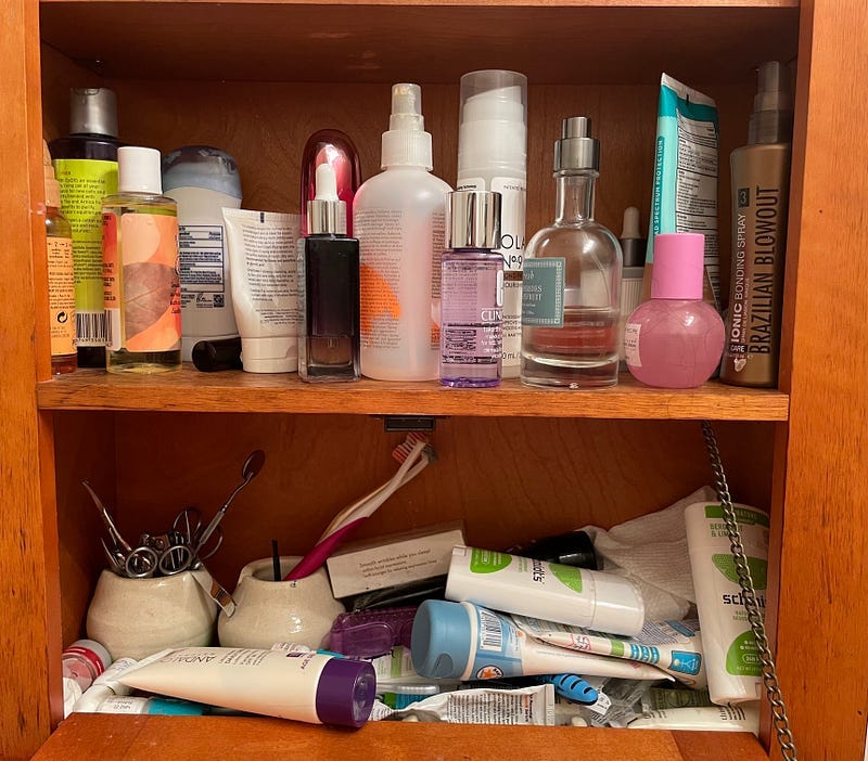 A messy, cluttered bathroom cabinet.
