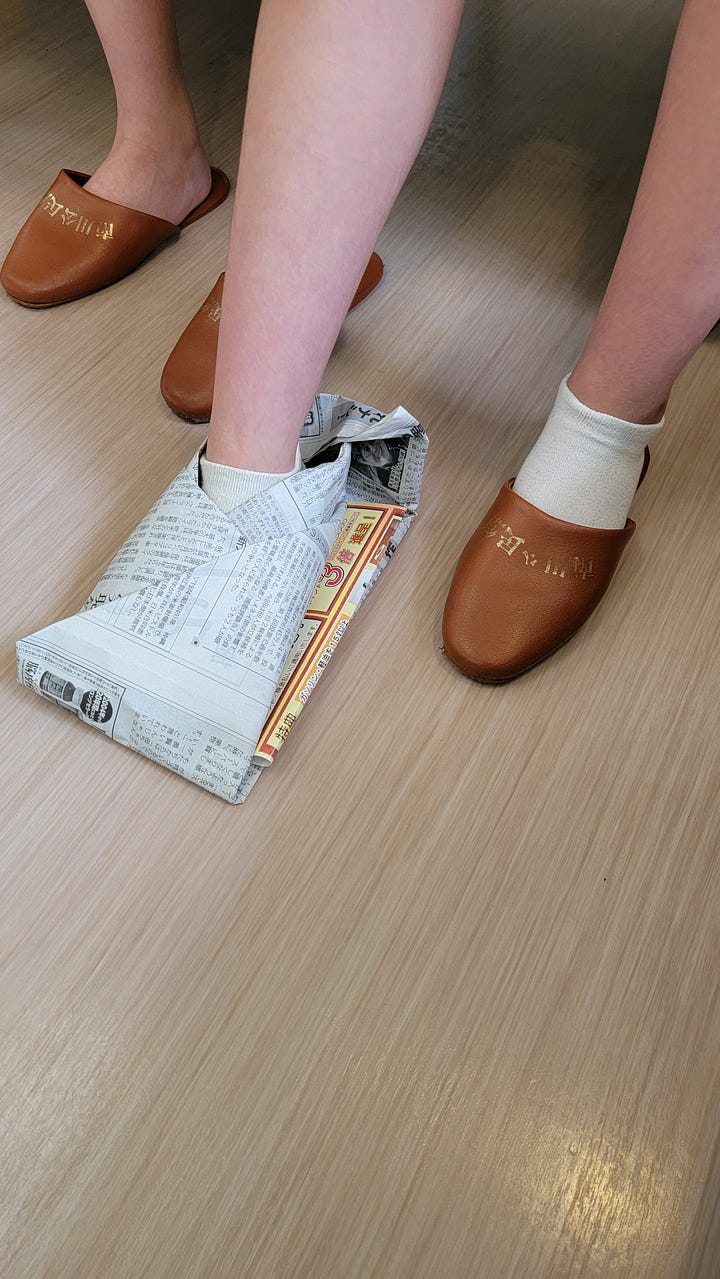 My daughter and me wearing newspaper shoes