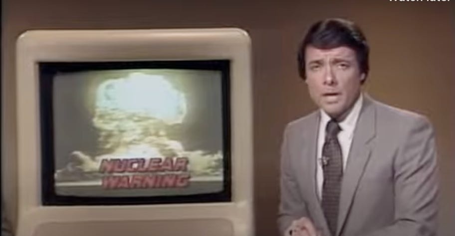 A person in a suit and tie standing in front of a television

AI-generated content may be incorrect.