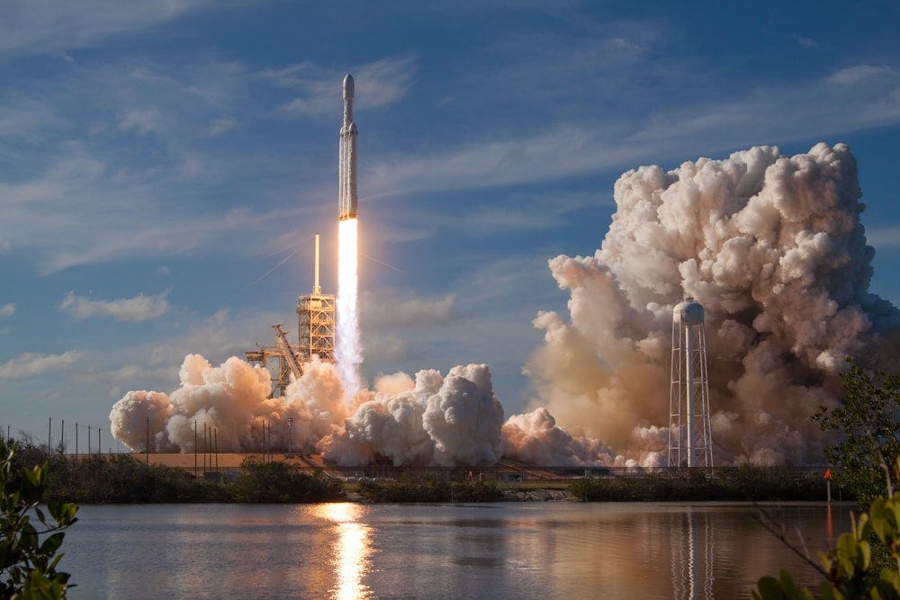 gray spacecraft taking off during daytime gray spacecraft taking off during daytime