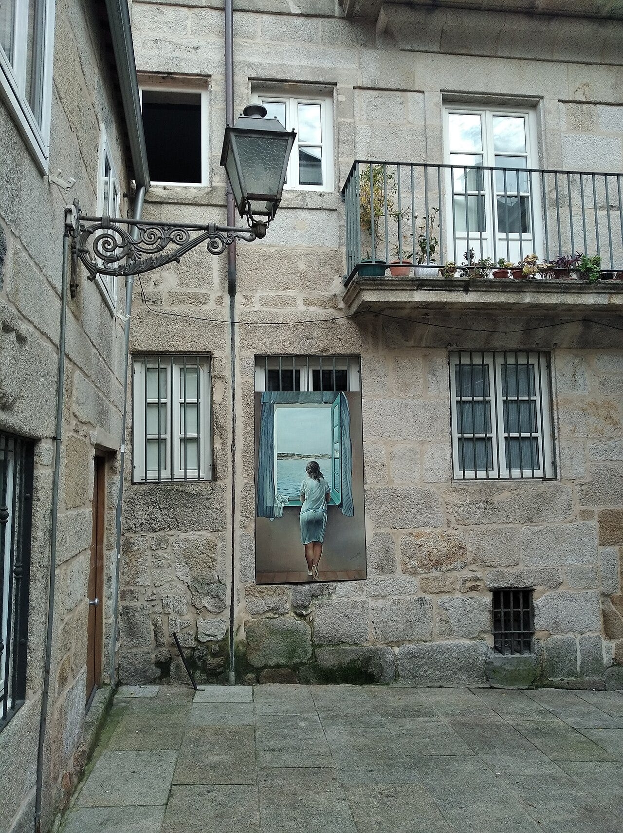 Young woman at a window over a calm bay Young woman at a window over a calm bay