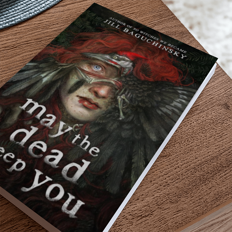 Book "May The Dead Keep You" on a table