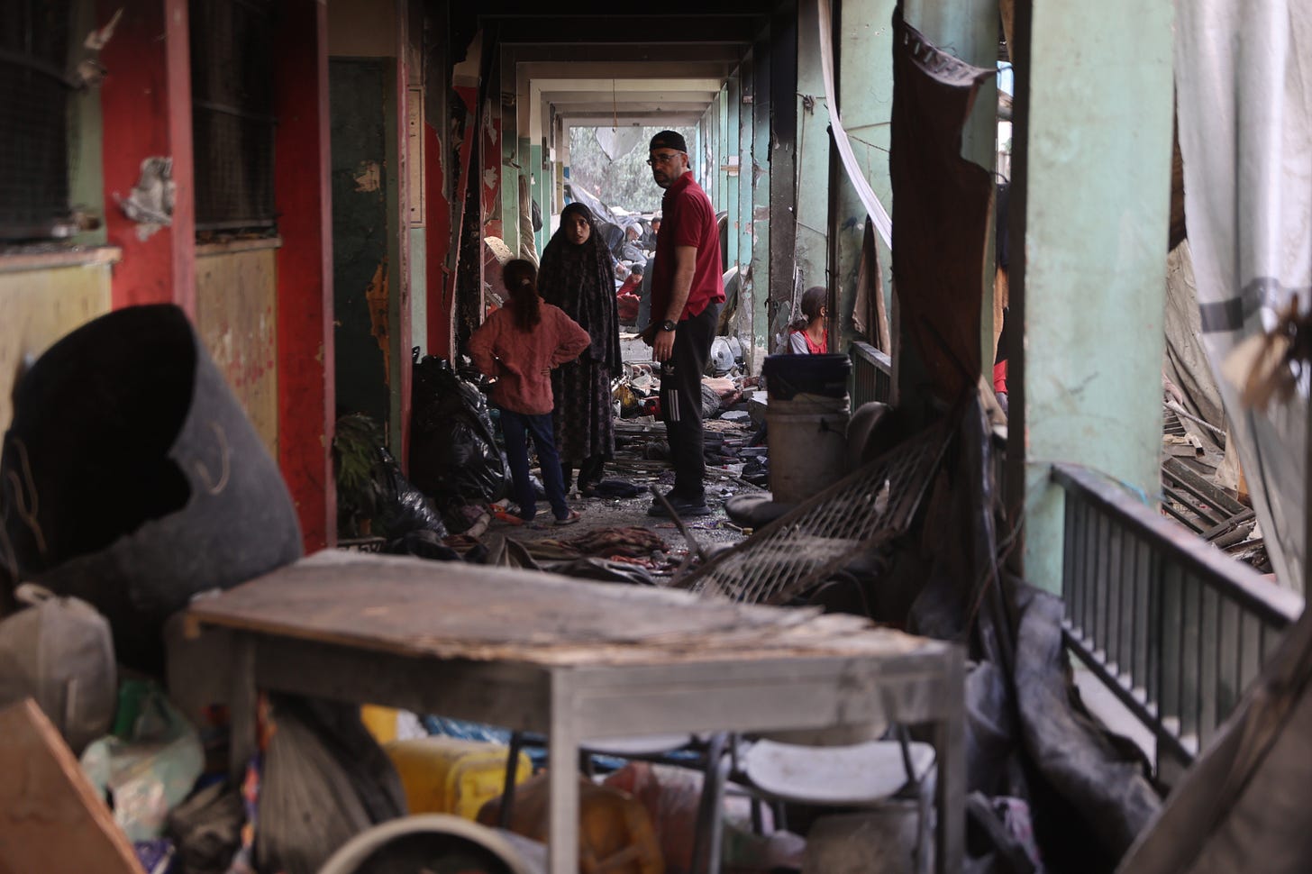 Palestinians walk the ruined hallways of the Fahmi Al-Jarjawi school, in the al-Daraj neighborhood of Gaza City, after it was targeted by Israeli airstrikes, May 31, 2025. (Omar Elqataa)