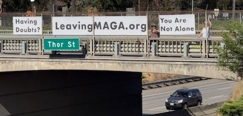 A handmade sign on a Washington state overpass supporting the Leaving MAGA movement.