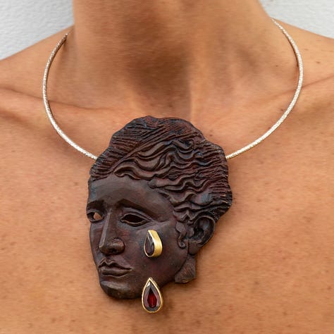 Hypatia ring; 22kt recycled gold, recycled platinum and natural diamonds; Hypatia Red brooch and pendant, 18kt recycled gold and garnets: Hypatia Green brooch and pendant, 22kt recycled gold, recycled silver, green garnets; all by Joy BC courtesy of Elisabetta Cipriani Gallery