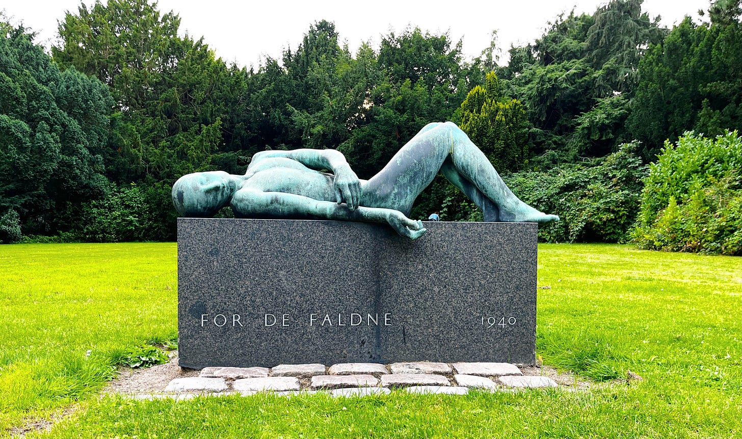 reclining youthful figure of verdigris on a simple plinth of polished gray stone, inscription reads For De Faldne 1940