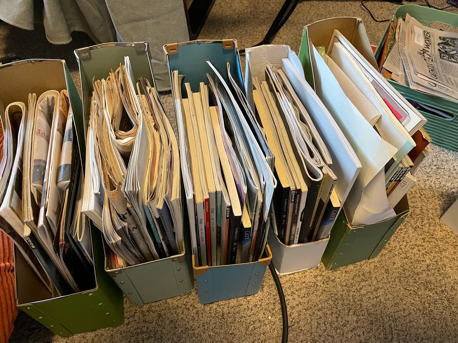 four file folders stuffed to the prim with newspapers and journals