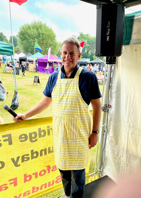 First image is of a hand holding a sample of drink, the second is of a man wearing a yellow and white striped apron at a food festival and the third shows a hand holding a sample of food with a Ukrainian flag in the background.