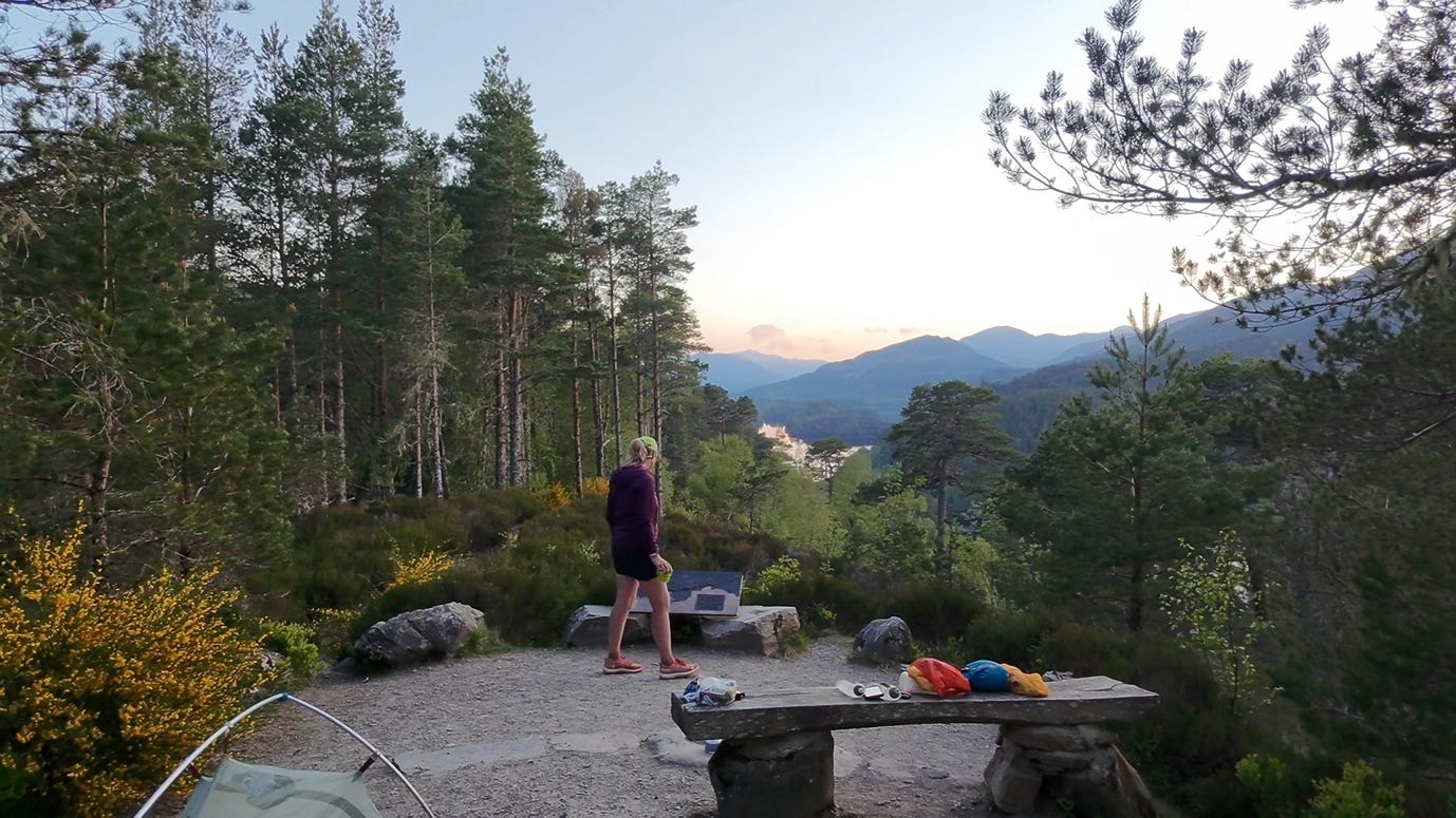 A person standing on a rock bench in the woods

AI-generated content may be incorrect.